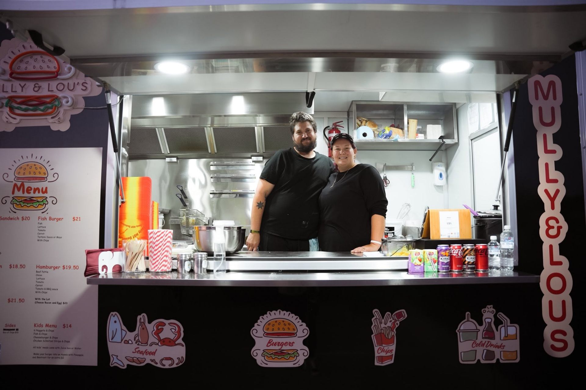 Mully & Lou's team inside the food van serving window